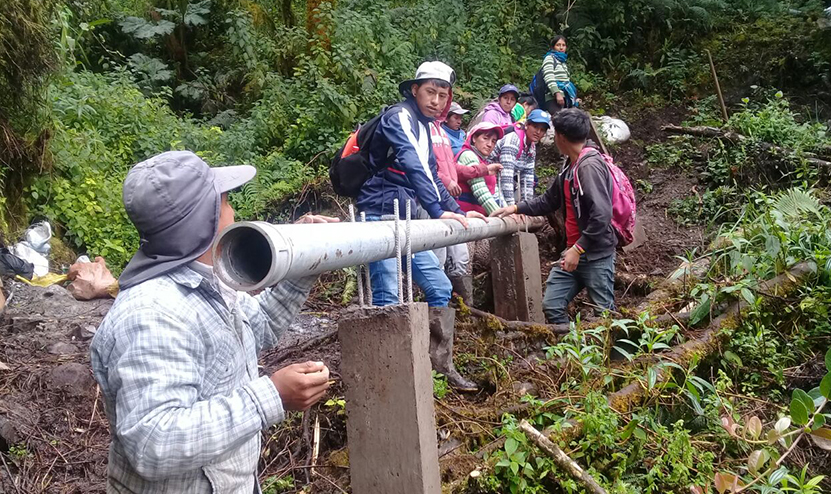 Groupe de personnes en train d'installer des canalisations en Andes équatoriennes