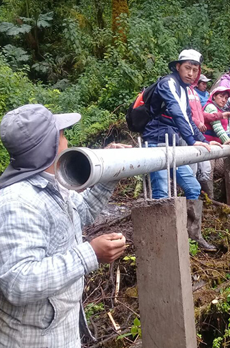 Groupes de personnes en train d'installer des canalisations d'eau  en Andes équatoriennes